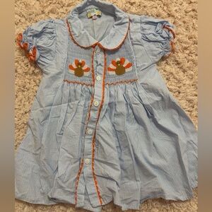 Smocked turkey button down dress with orange trim